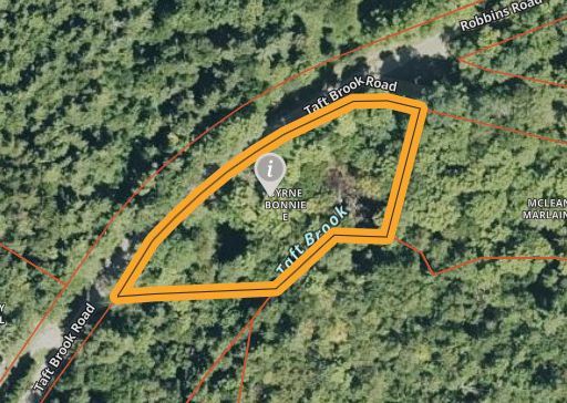 Aerial map with an orange outlined trail loop through dense forest near road labels