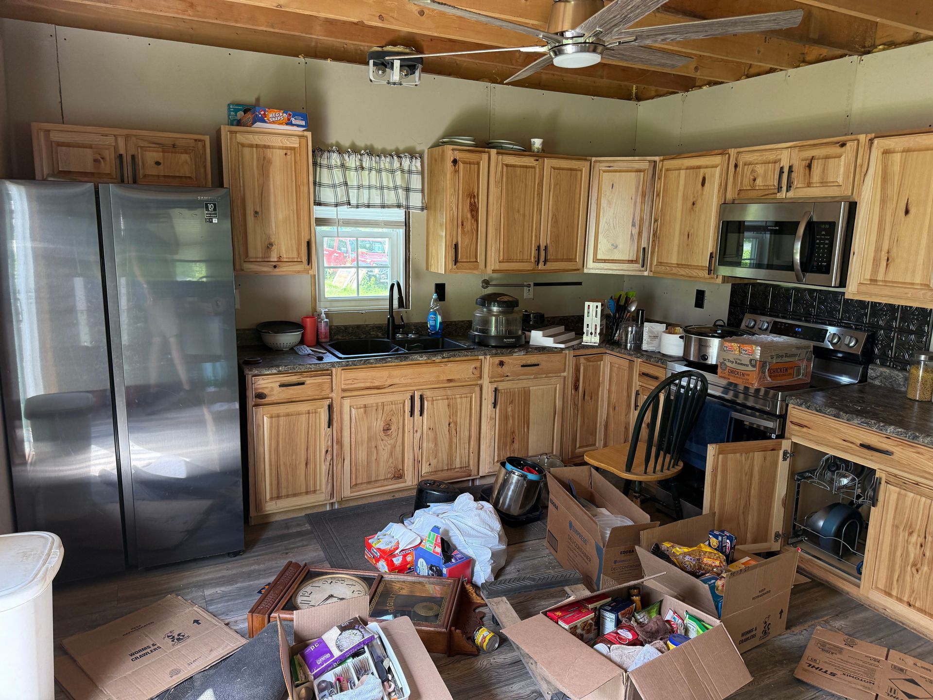 kitchen with wooden cabinets, stainless fridge