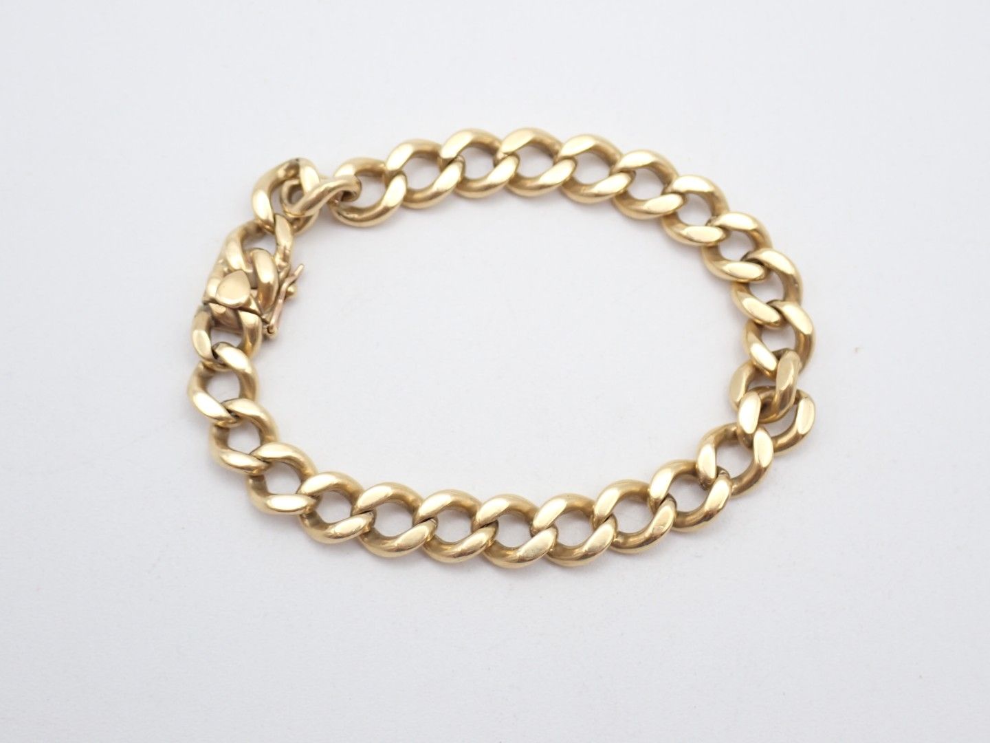 Gold chain bracelet on a white background
