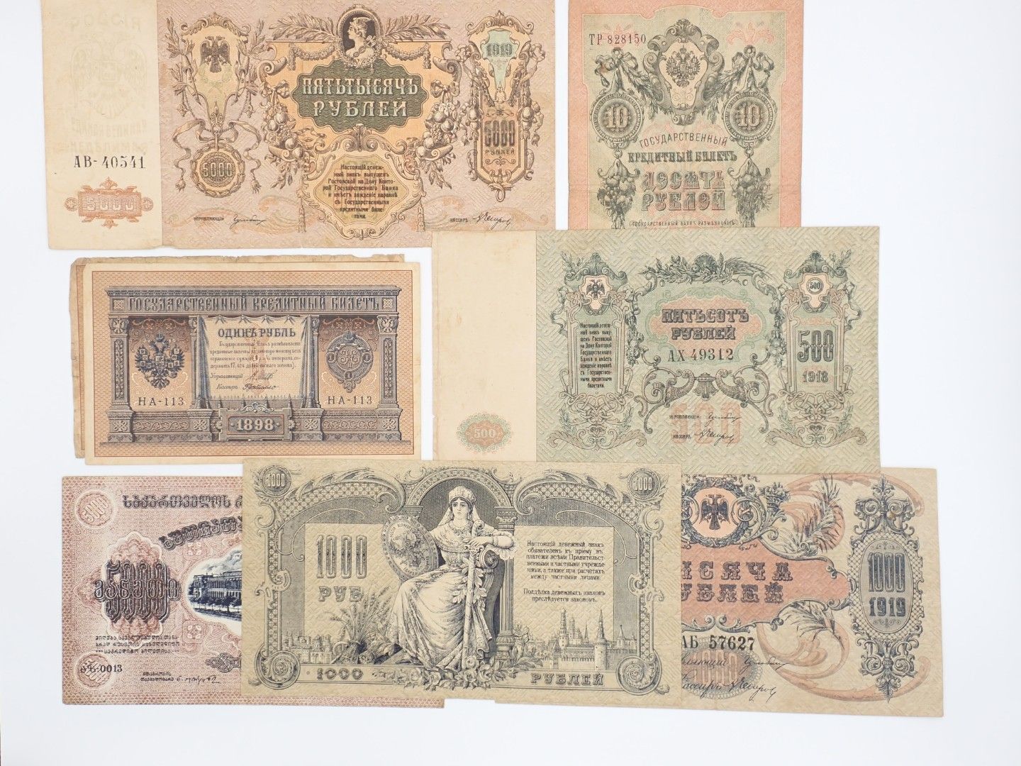 Assorted vintage banknotes in beige, green, and blue tones arranged in a collage.
