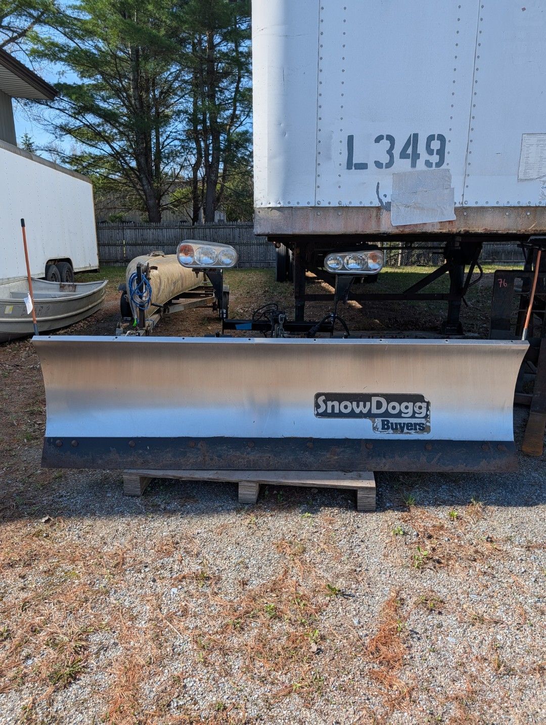 SnowDogg snowplow blade mounted on a trailer