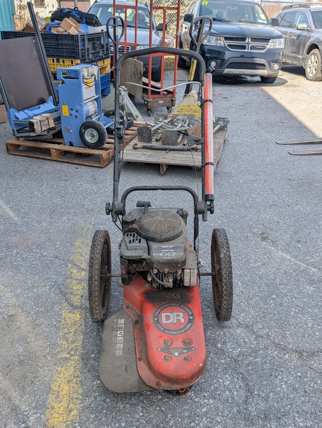 Red push lawn mower with black handle