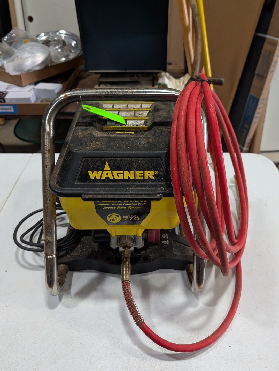 Wagner spray paint machine with red hose coiled