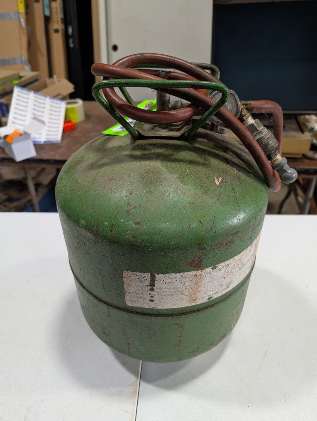 Green metal cylinder with coiled wires on top