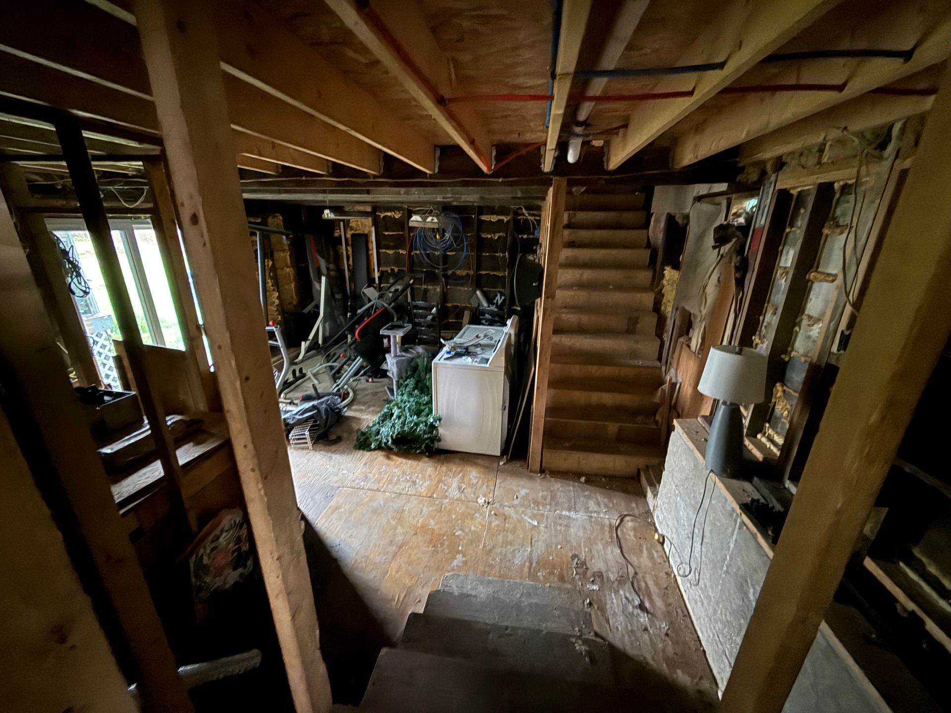 Basement with exposed beams, stairs