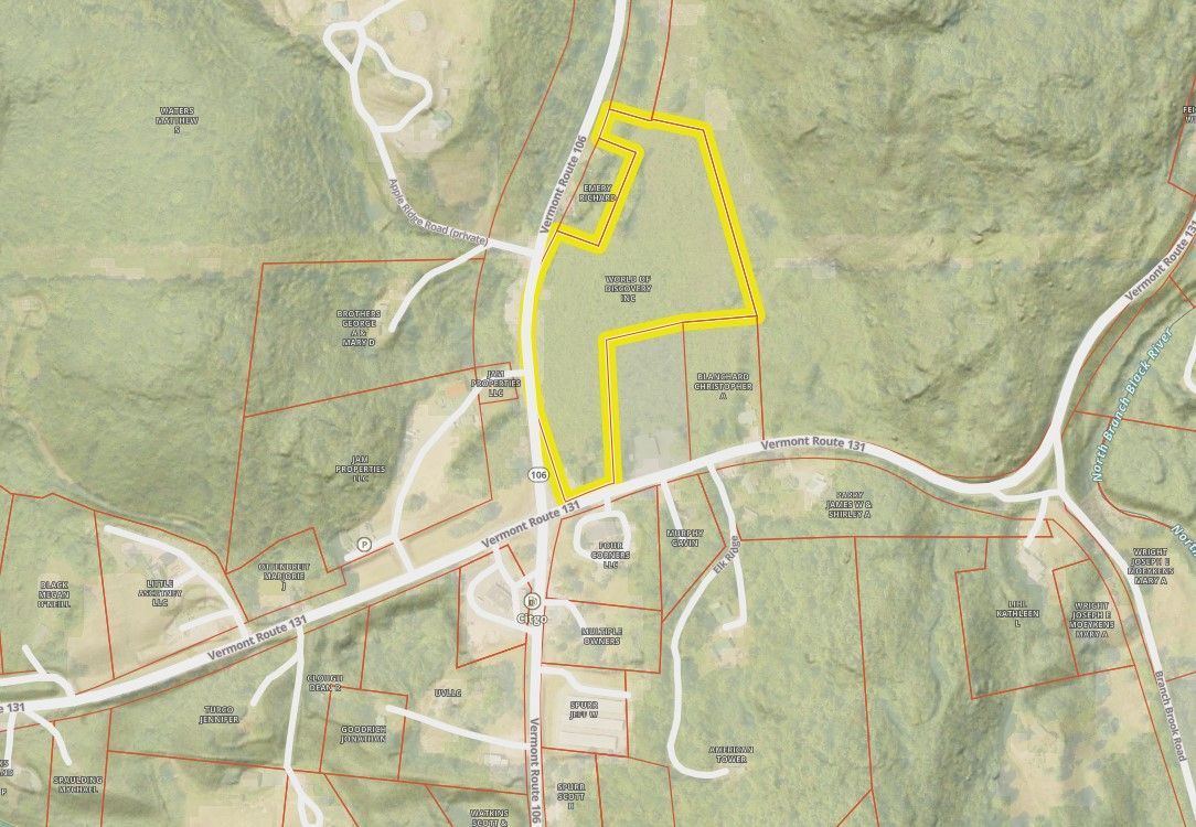 Topographic map with a yellow outlined property through a town and surrounding hills