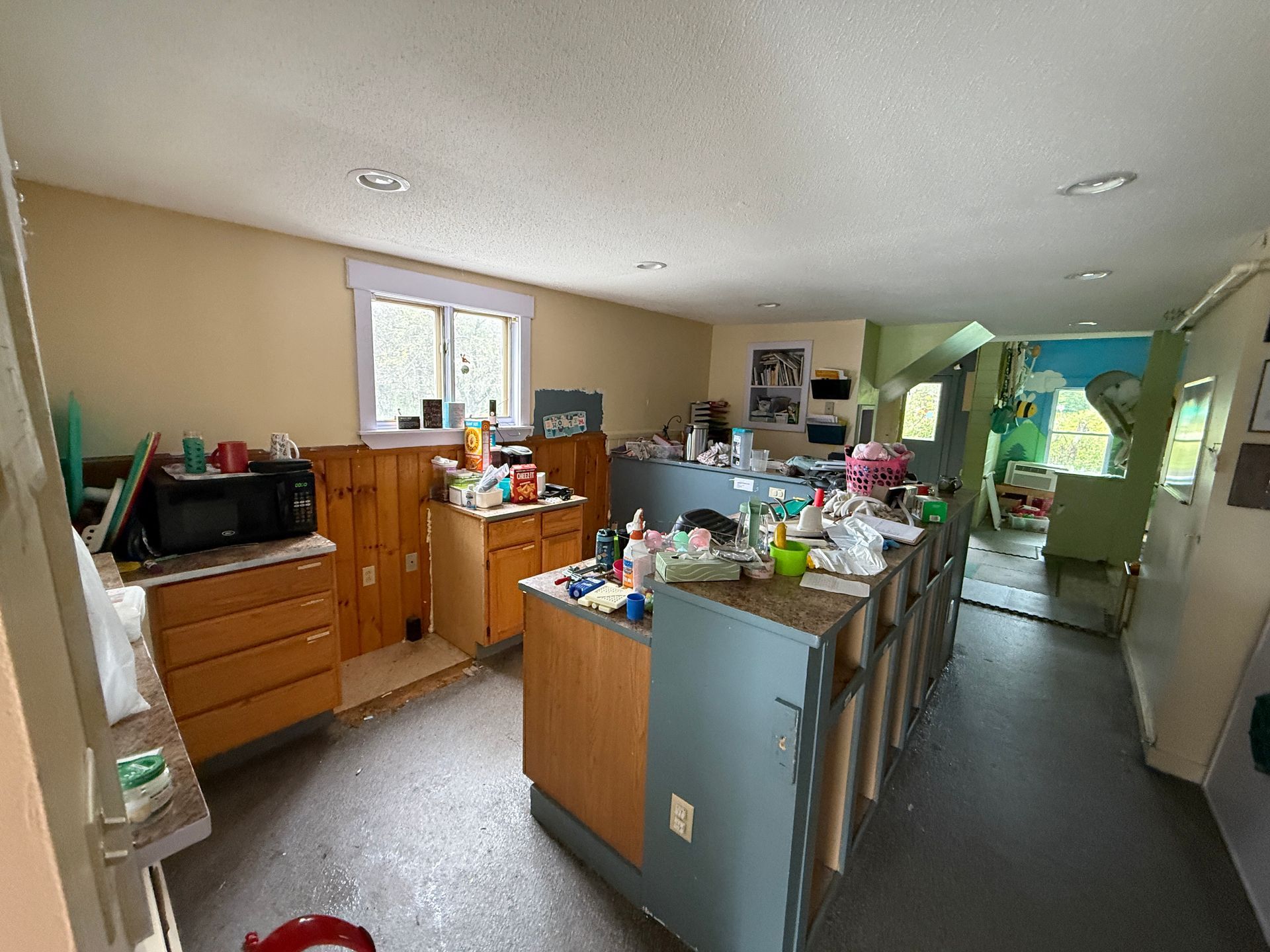 kitchen with central island, wooden cabinets, white refrigerator, and a window over the sink