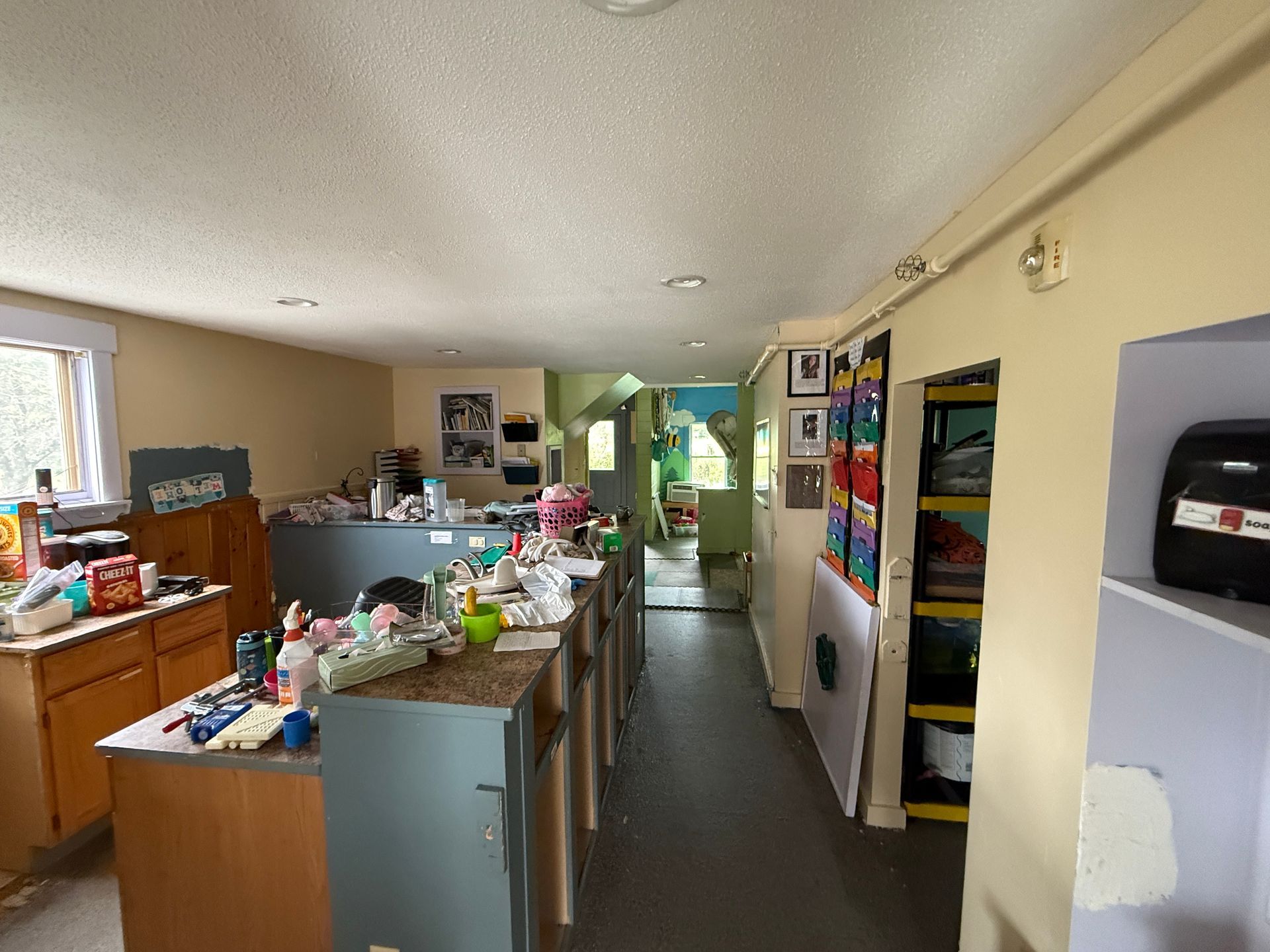 Long indoor hallway with counters, shelves, and colorful displays