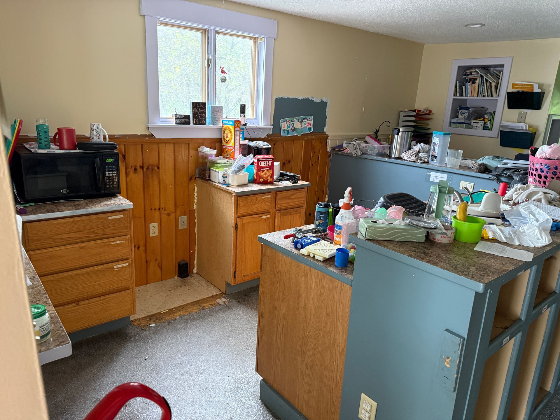 kitchen with blue cabinets, wooden counters, and assorted items