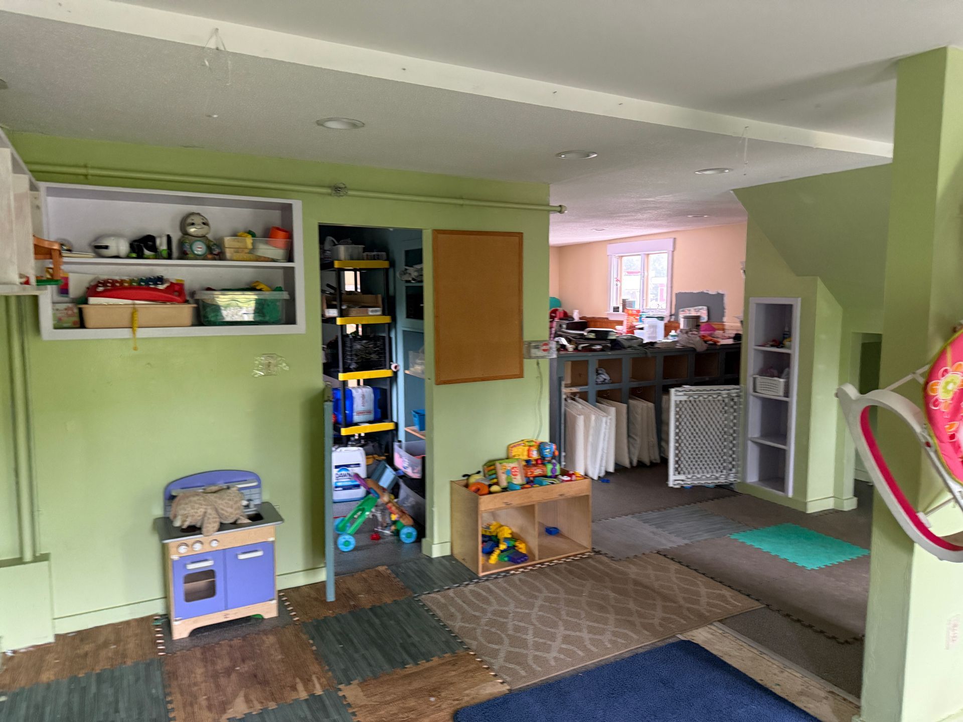 Green-walled indoor space with shelves, a doorway