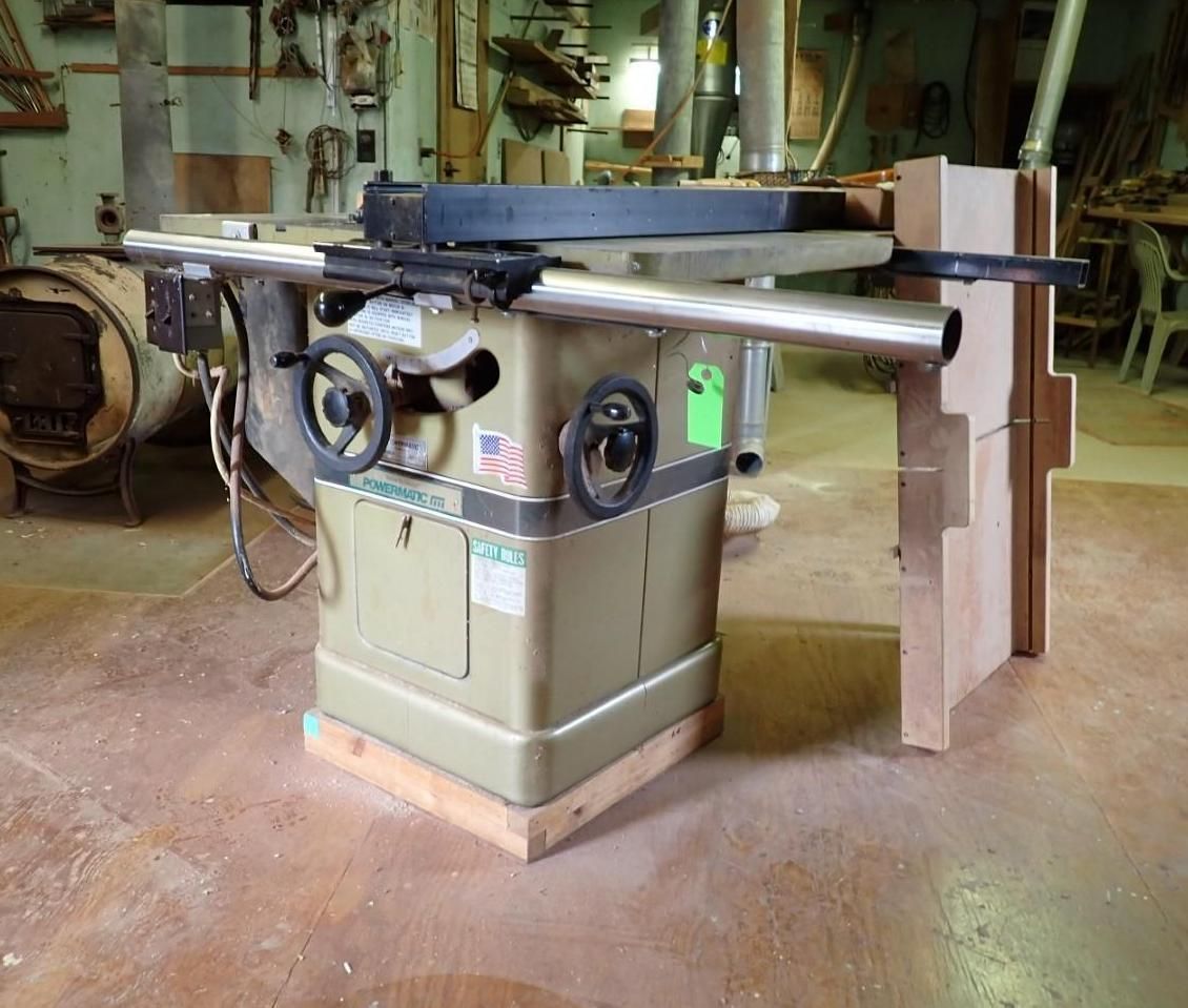 Woodworking table saw with cast-iron surface and fence in a workshop