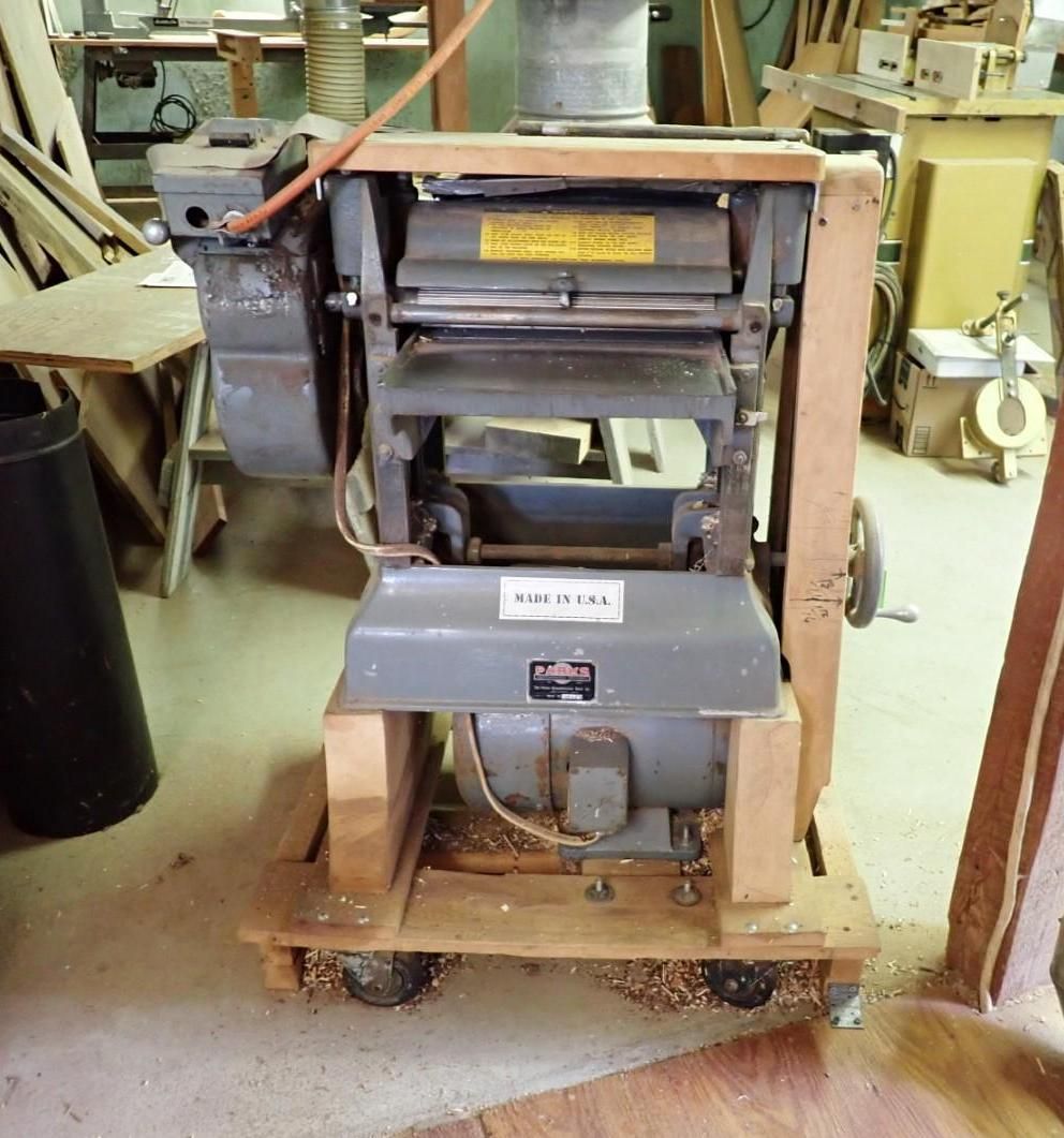 Gray industrial machine on a wooden pallet in a workshop