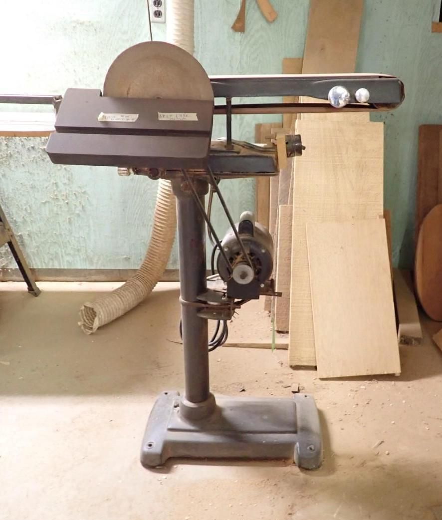 Old bench-top saw with round blade and black motor