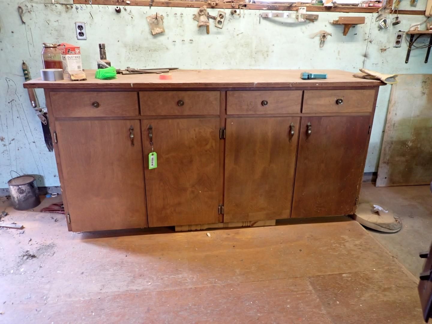 Wooden workbench with cabinets in a worn workshop