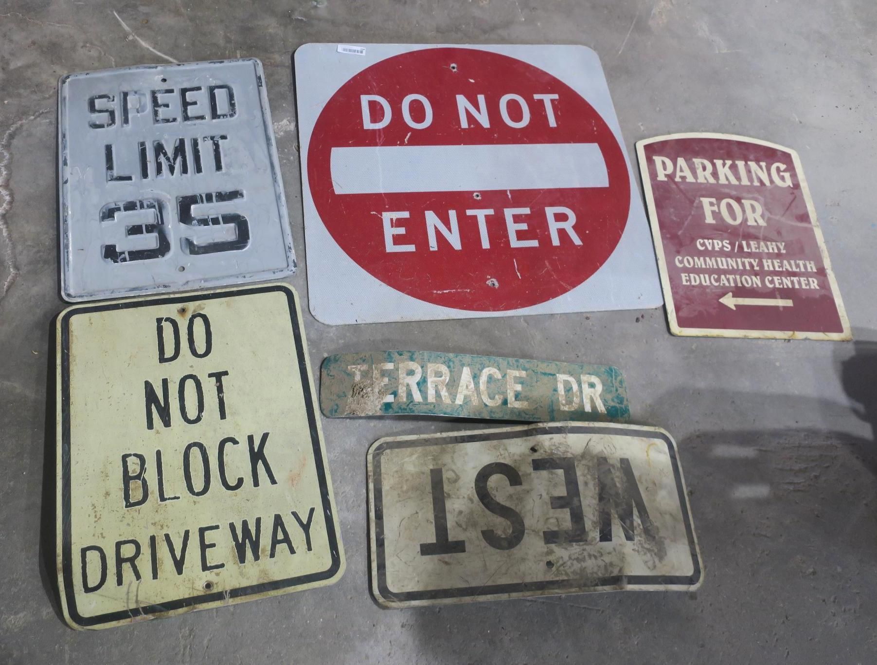 Assorted parking and street signs, including speed limit 35, do not enter, and do not block driveway.