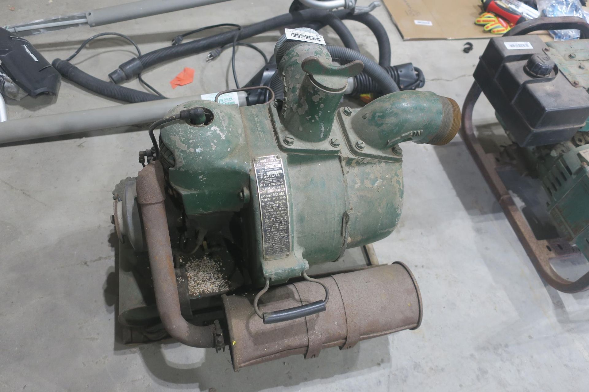 Green portable air compressor on a concrete floor