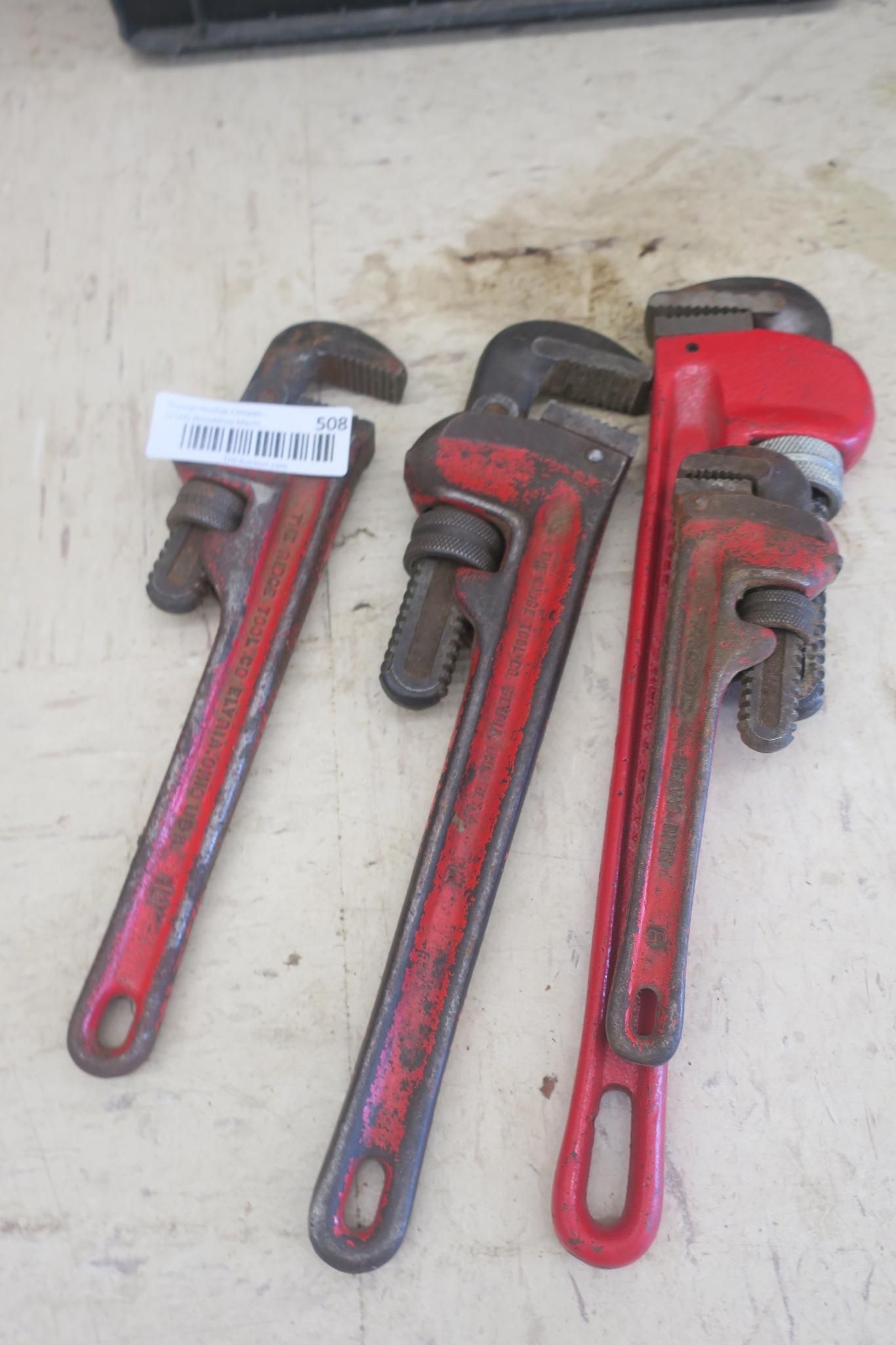 Three red pipe wrenches
