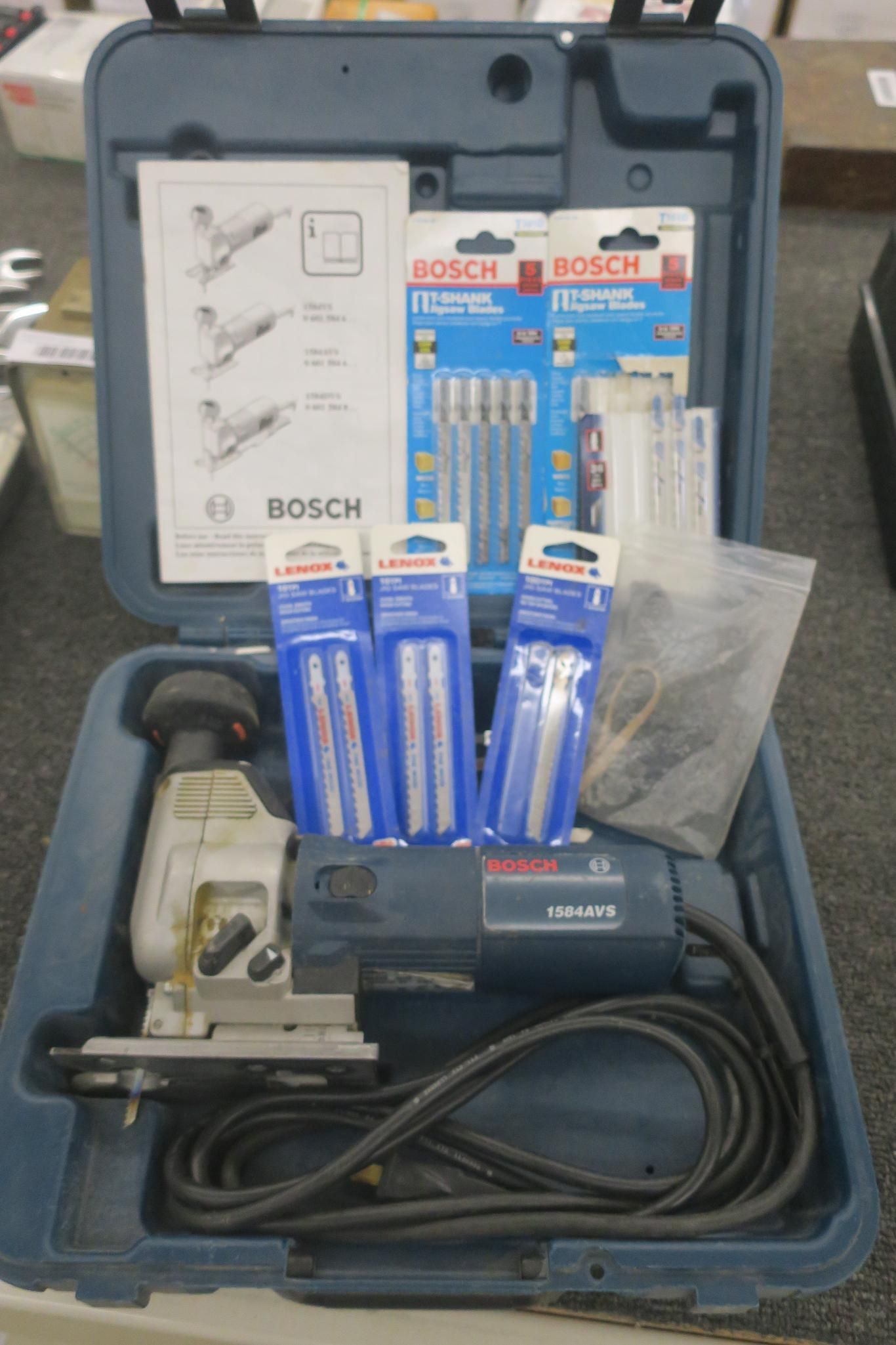 Bosch tool kit case with power tool, drill bits, and accessories inside a blue case.
