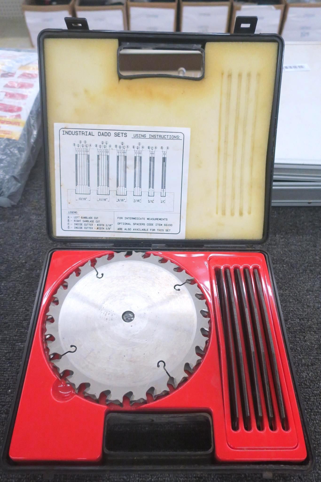 Open case with red base showing circular metal saw blade and accessory rods in a molded tool kit.