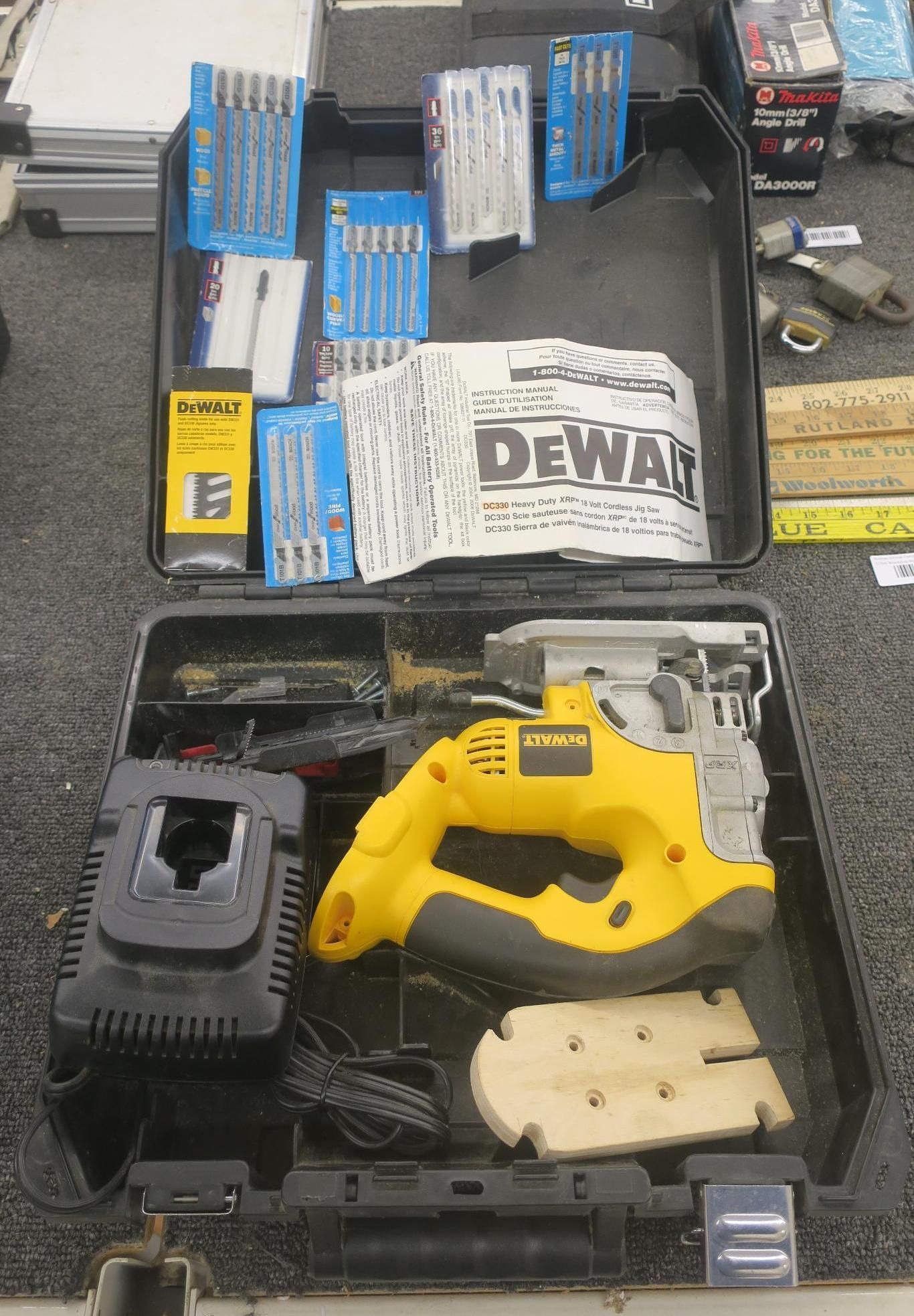 Open case with yellow DEWALT tool and drill bits, plus boxed accessories on a work surface.
