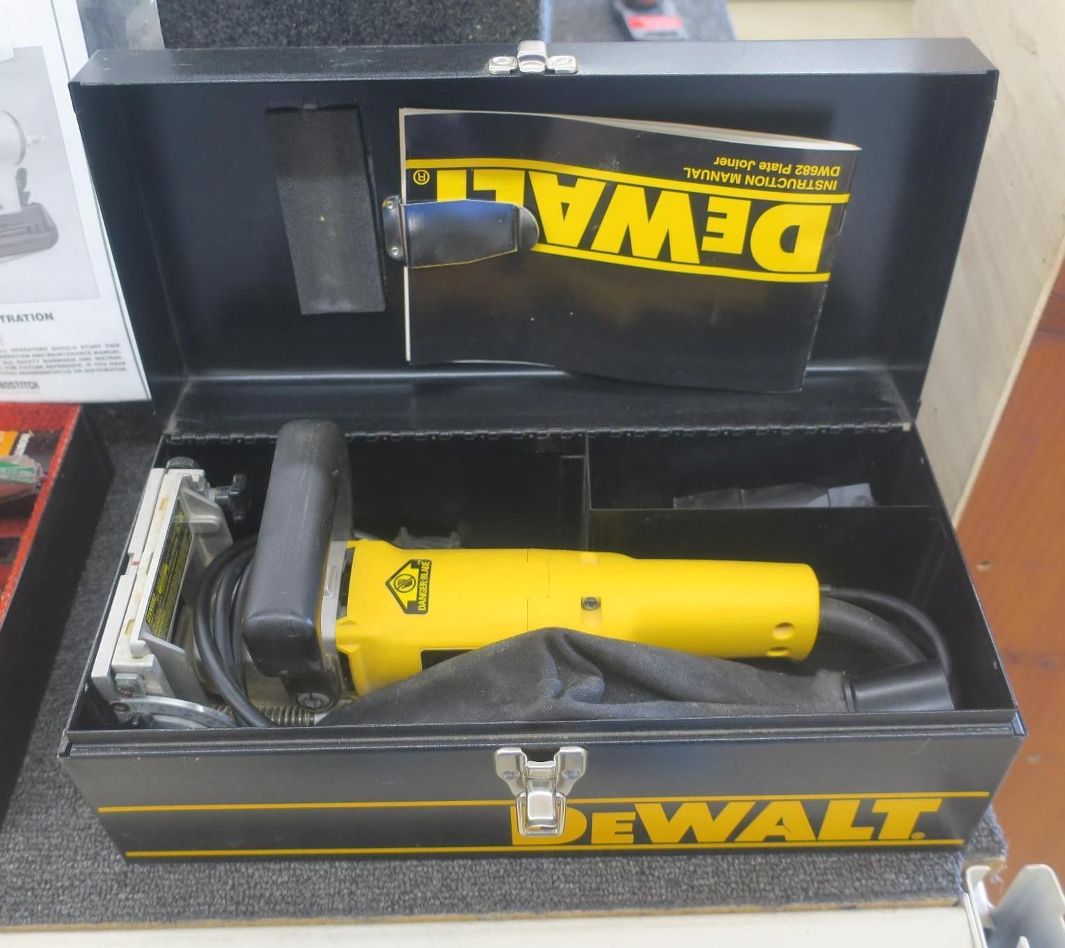 Yellow DeWalt power tool in an open black DeWalt case on a store shelf.