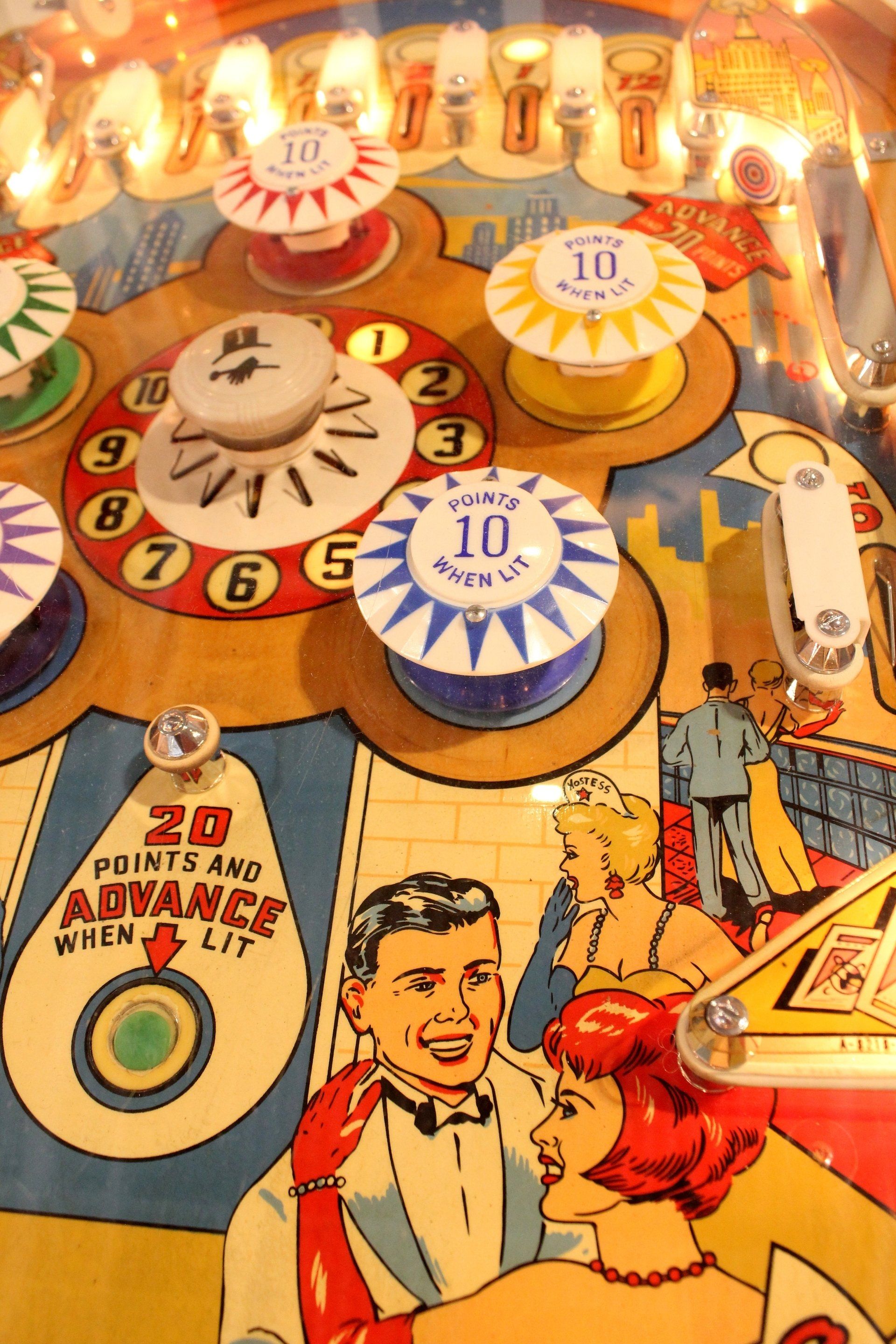 Pinball machine playfield with illuminated targets.