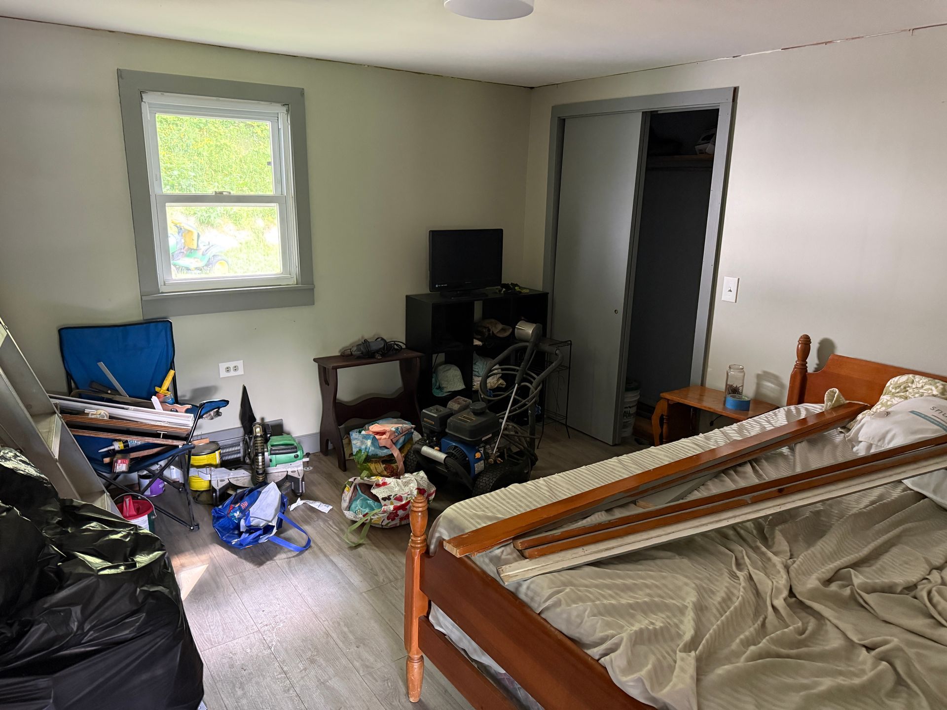 bedroom with a bed and a small TV near a window.