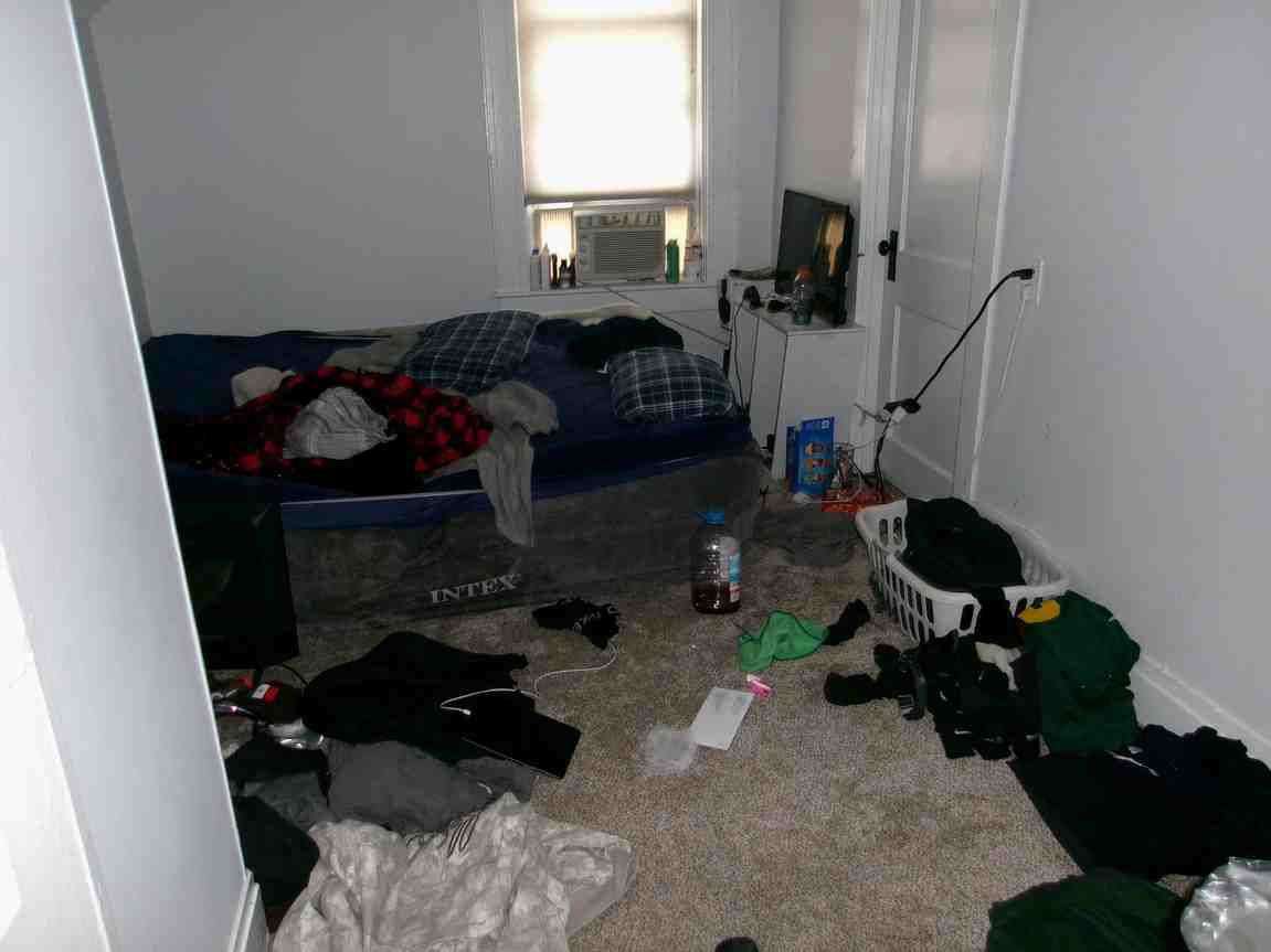 bedroom with a bed and a window at the back.