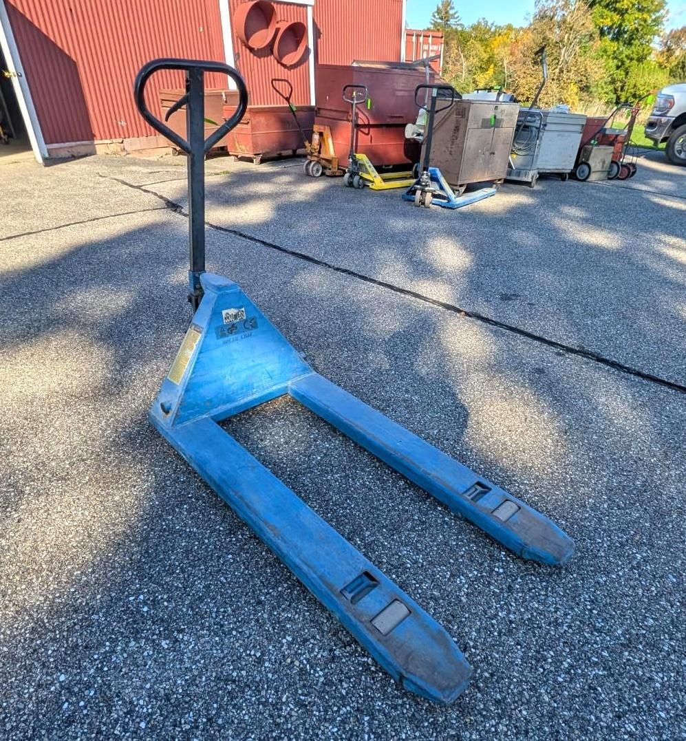 Blue pallet jack on gravel