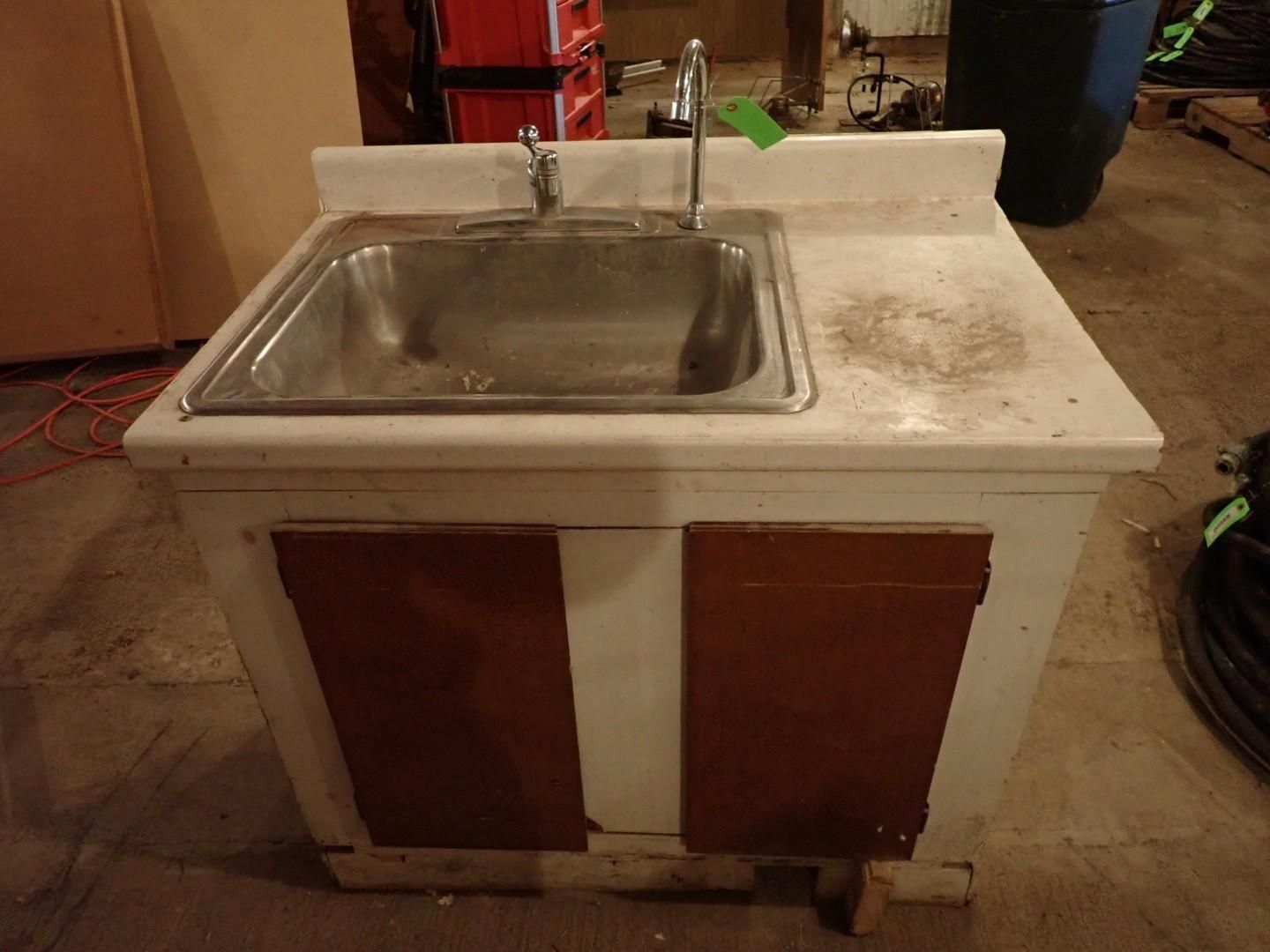 Old sink cabinet with stainless steel basin