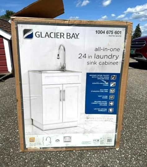 Glacier Bay all-in-one 24-inch laundry sink cabinet box on a pallet outdoors