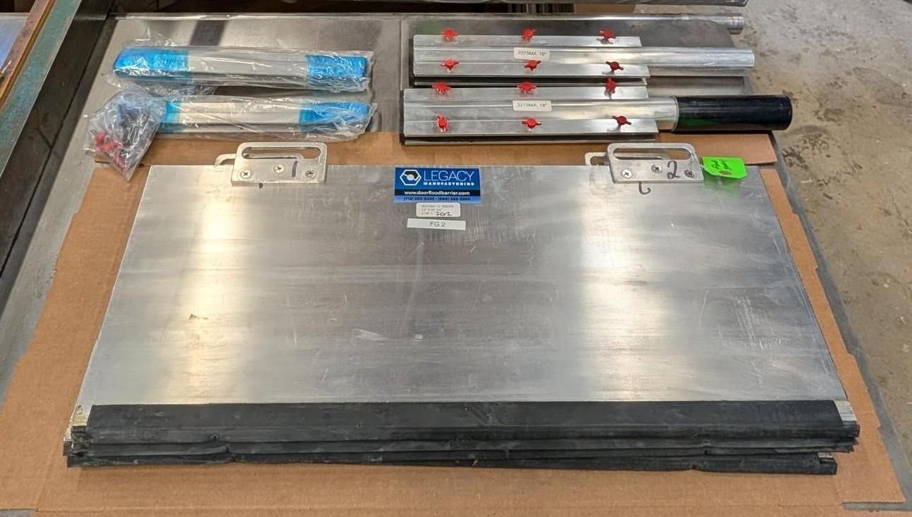 Metal tool kit with silver plates and wrapped rods arranged on a wooden workbench.
