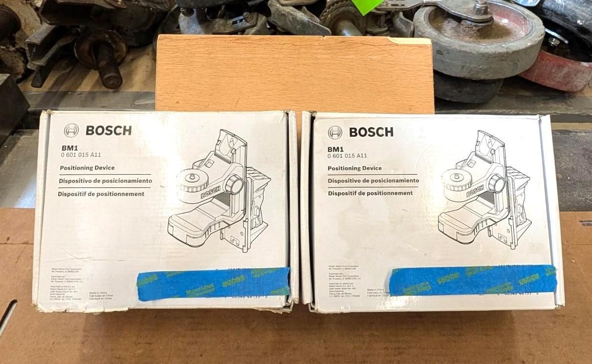 Two Bosch product boxes on a workbench, with a wooden block behind them.