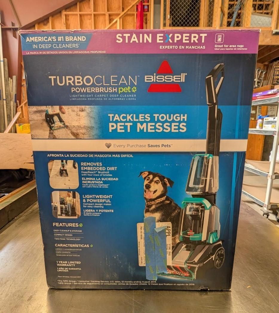 Bissell TurboClean carpet cleaner box for pet messes, blue and pink, in a store aisle