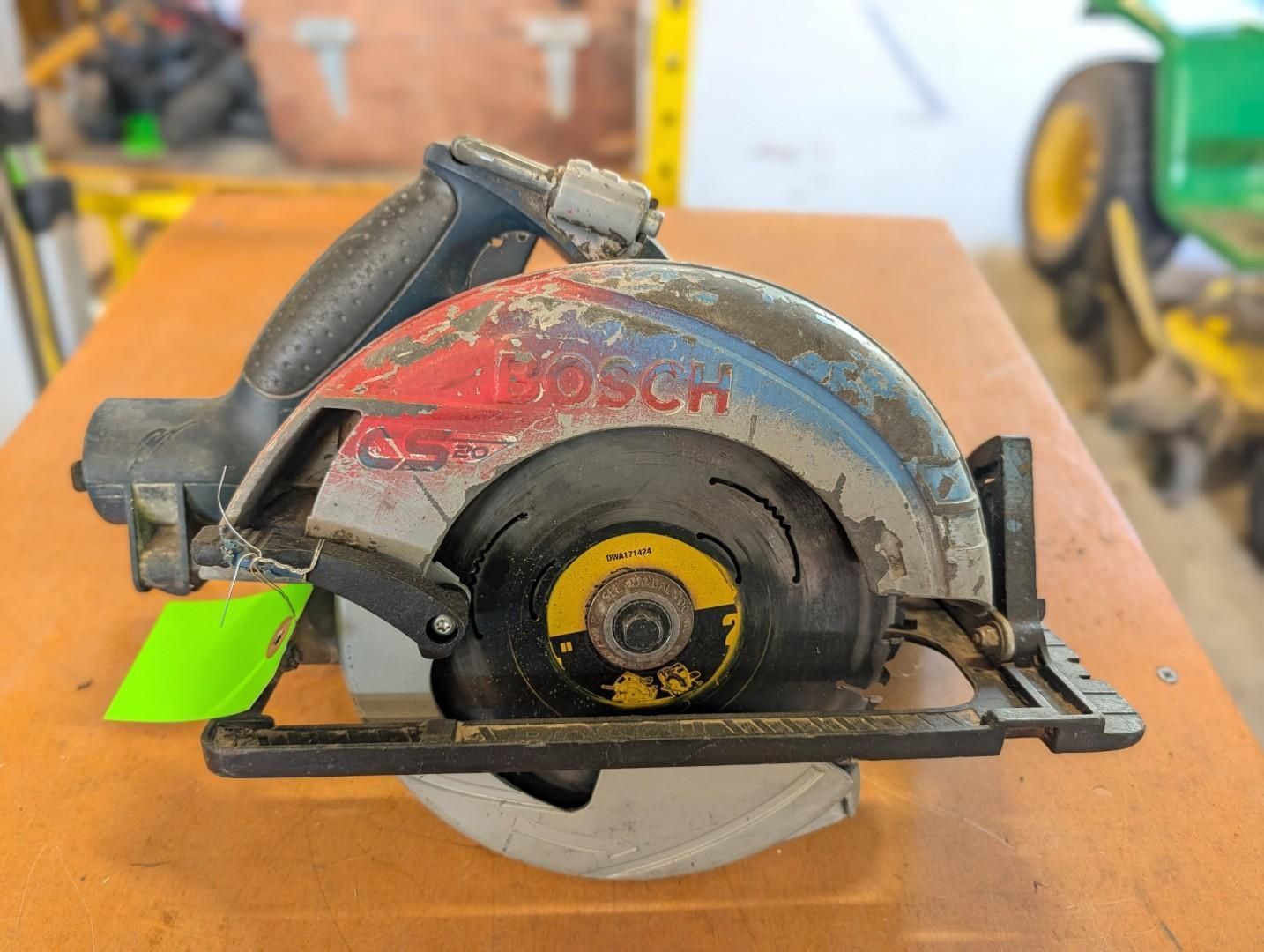 circular saw with gray housing and red markings on a workbench