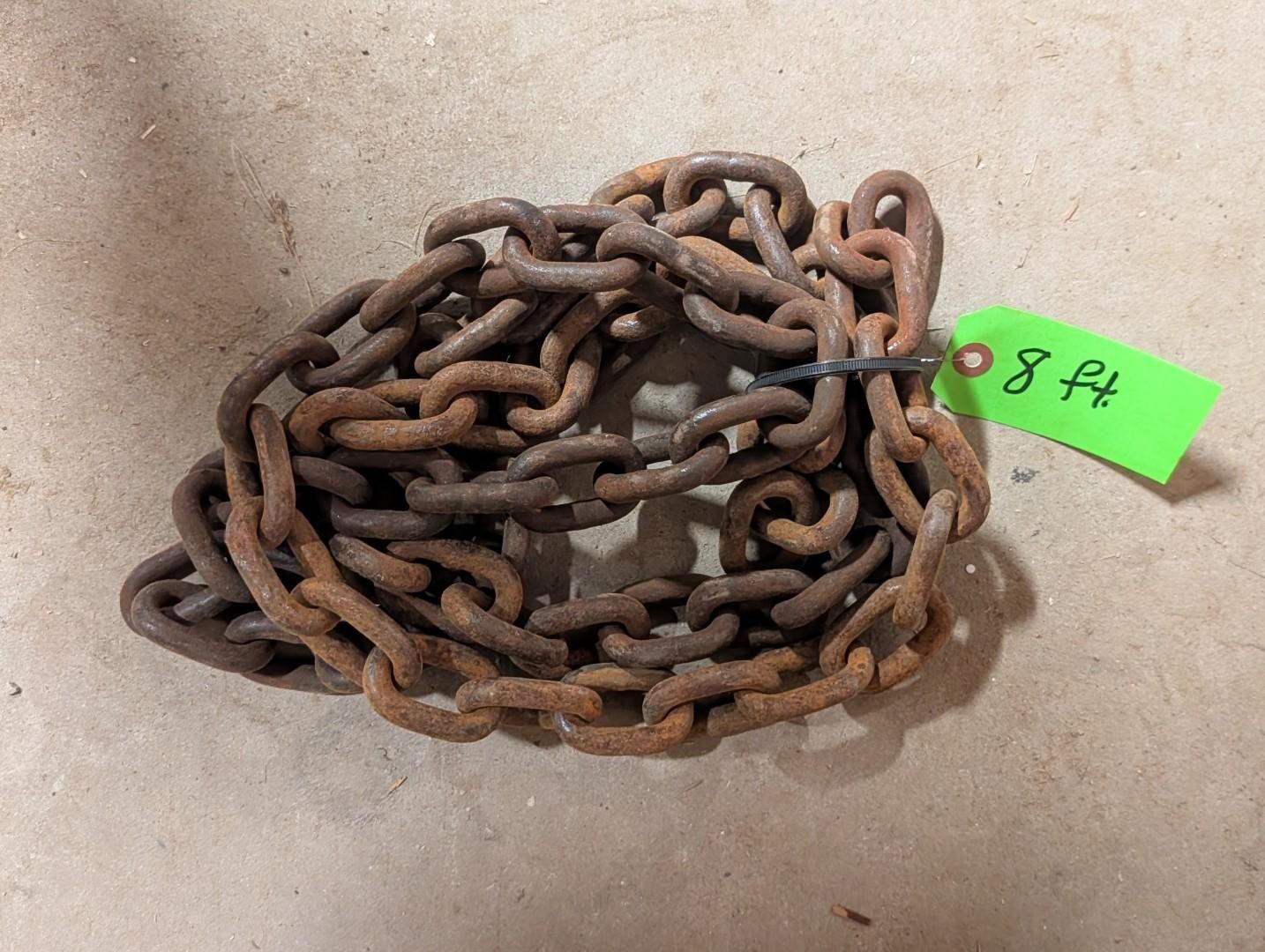 coiled chain with a green tag marked “8 ft” on a beige surface