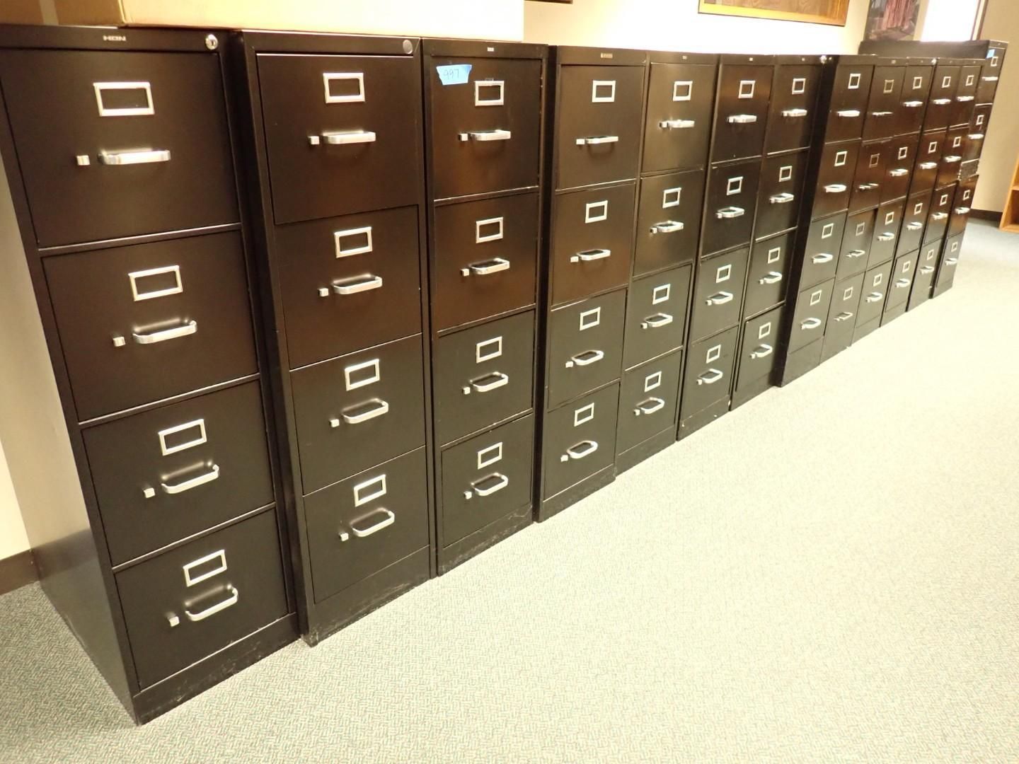 Rows of brown filing cabinets lining an office hallway with beige carpet.