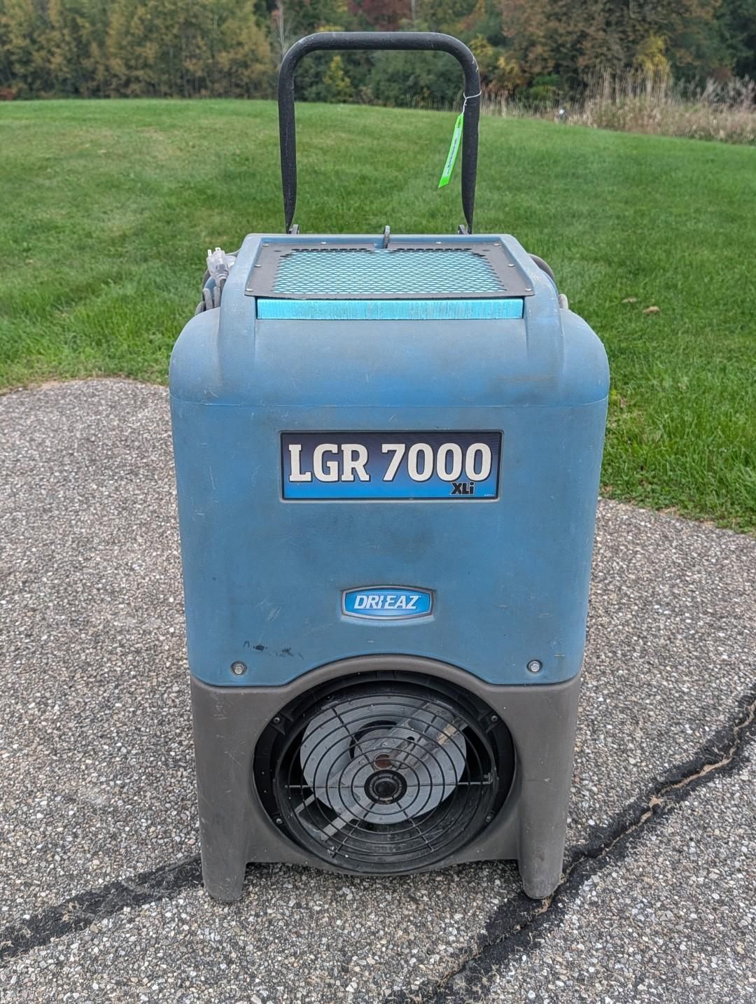 Blue LGR 7000 dehumidifier on a driveway, front view with handle and fan opening