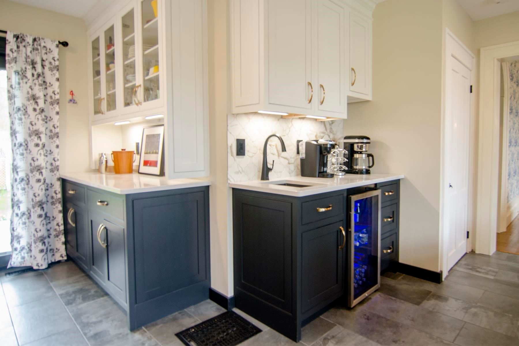 Kitchen with blue cabinets, white countertops, a sink, and a beverage cooler.