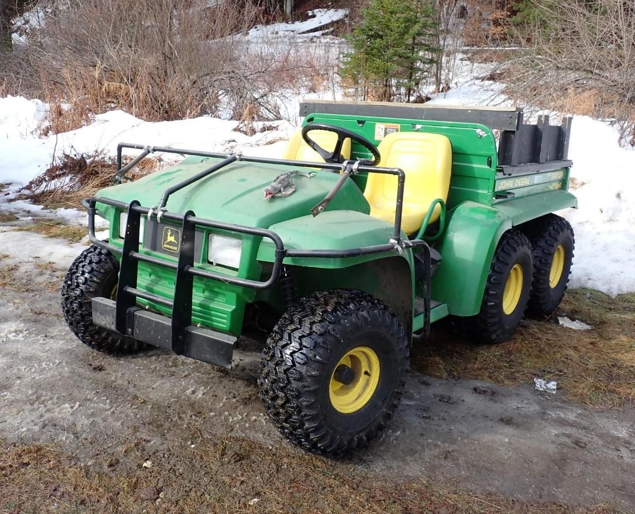 Green six-wheeled utility vehicle with yellow tank