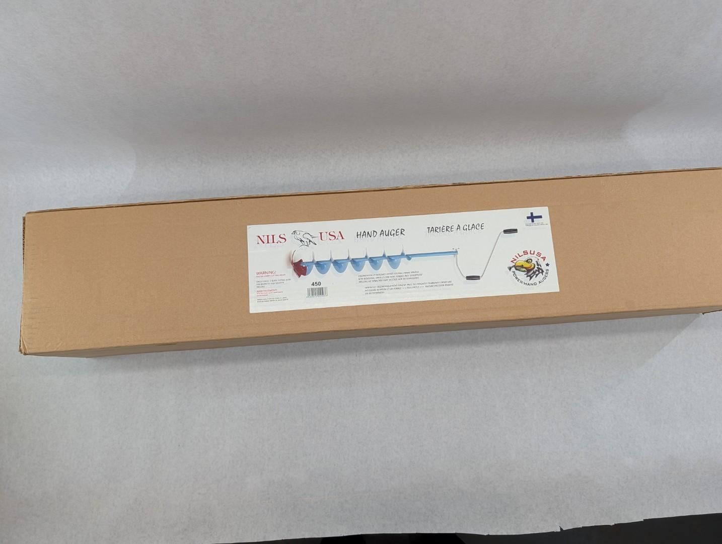 Long cardboard box with a white label on a light surface