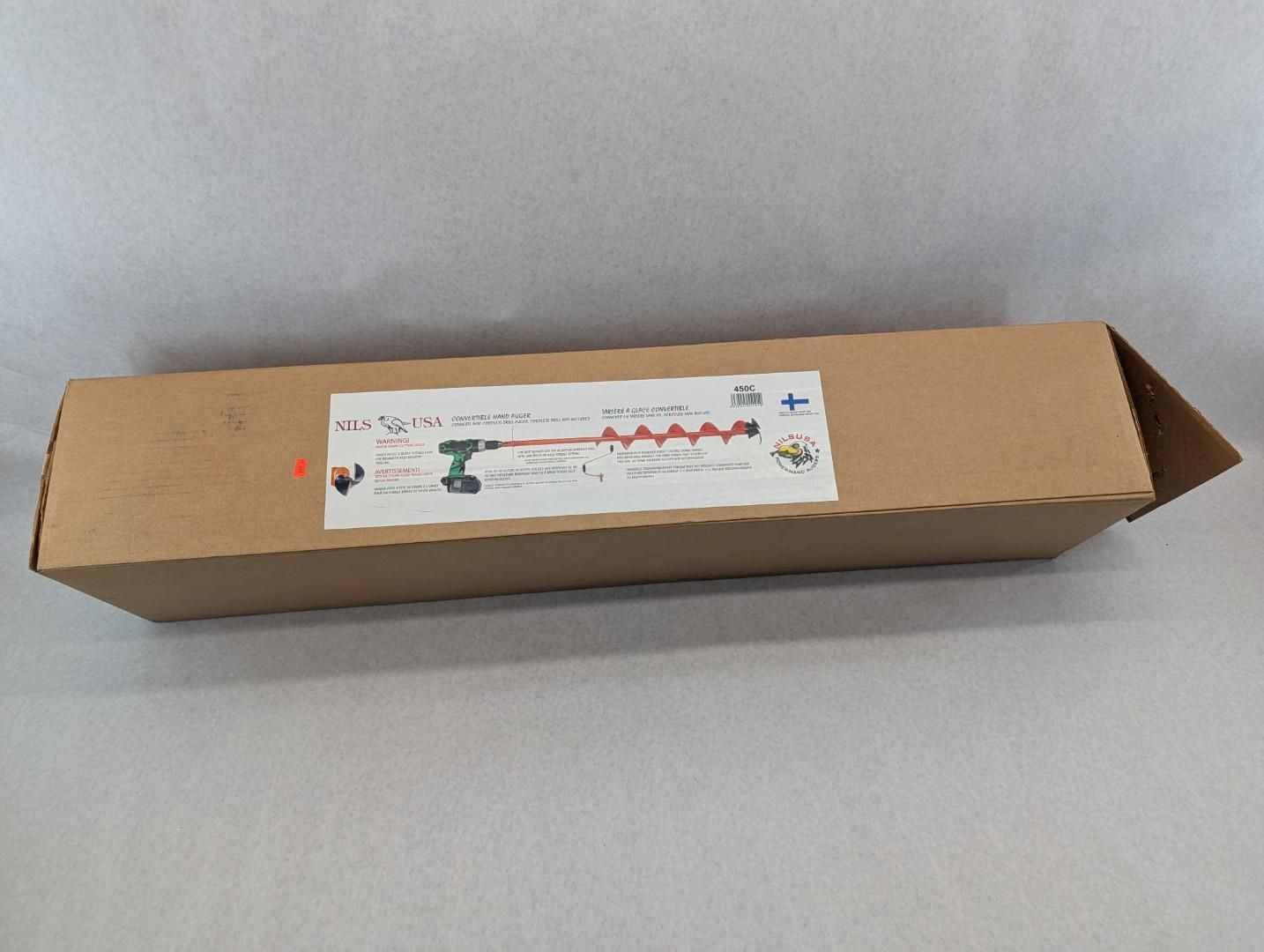 Long brown cardboard box with a white label on a gray surface