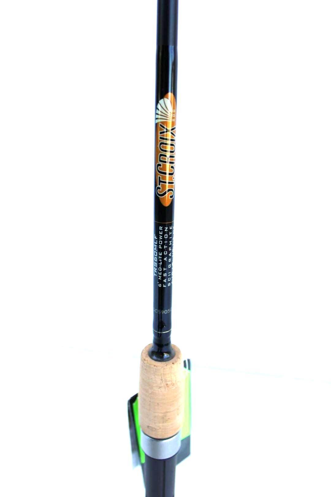 Black fishing rod with cork handle and colorful label, standing upright in a holder