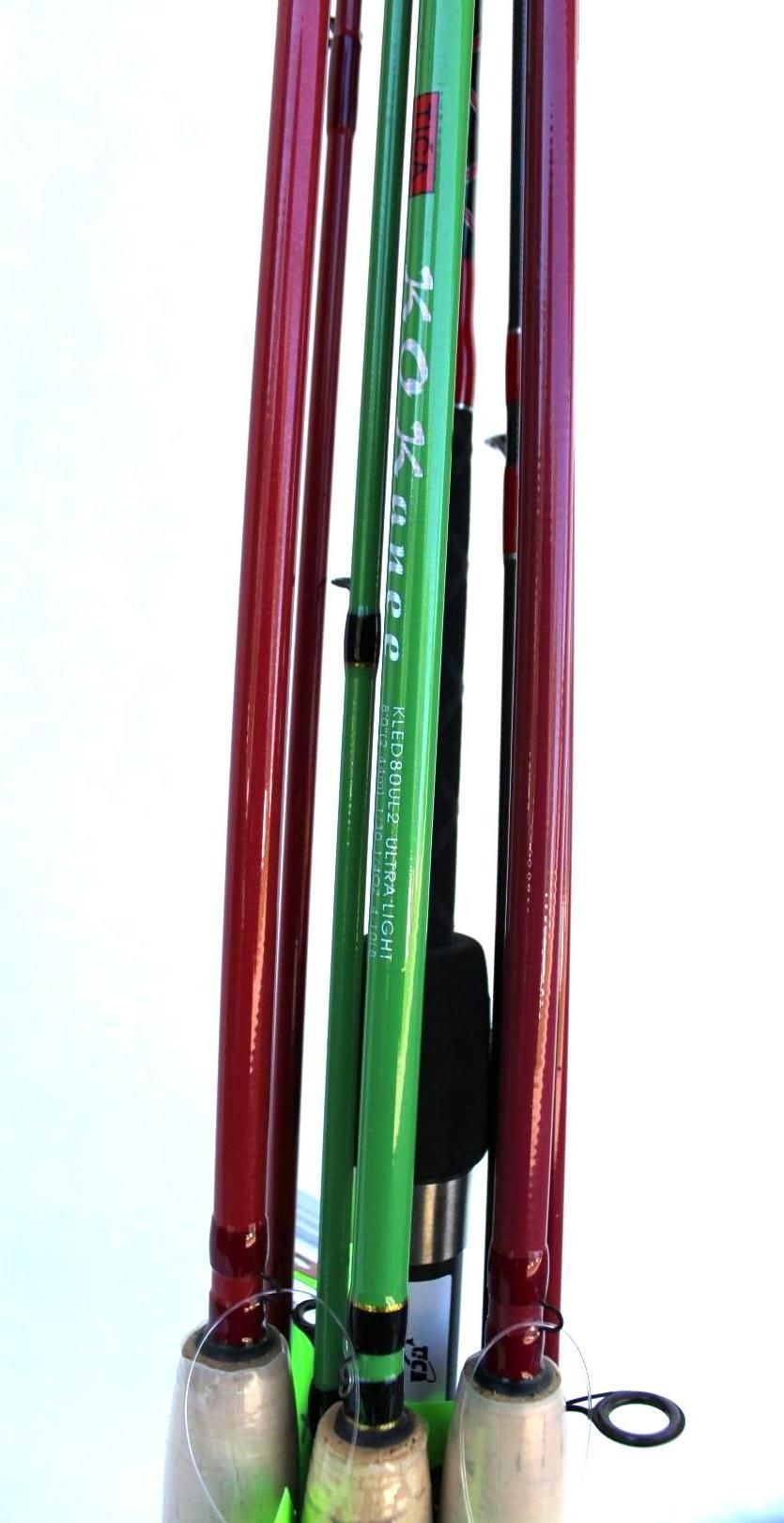 Assorted colorful fishing rods standing upright against a white background
