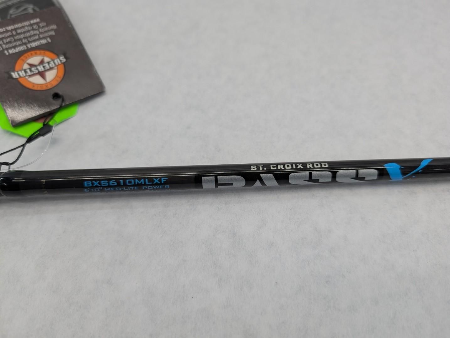 Black and blue fishing rod shaft on a gray surface with a tag in the corner