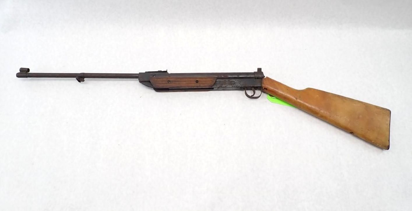 Long-barreled rifle with a wooden stock on a plain white background