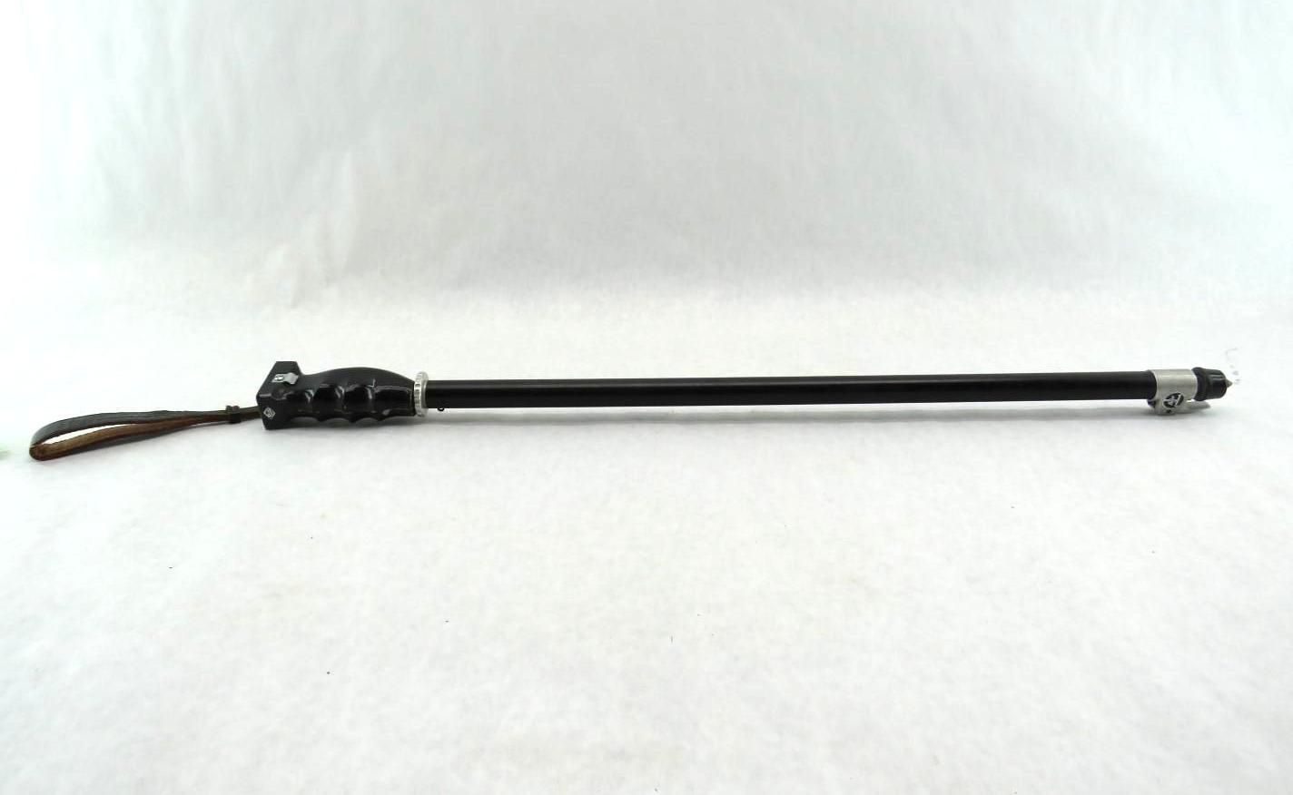 Black rod with a looped handle on a white background