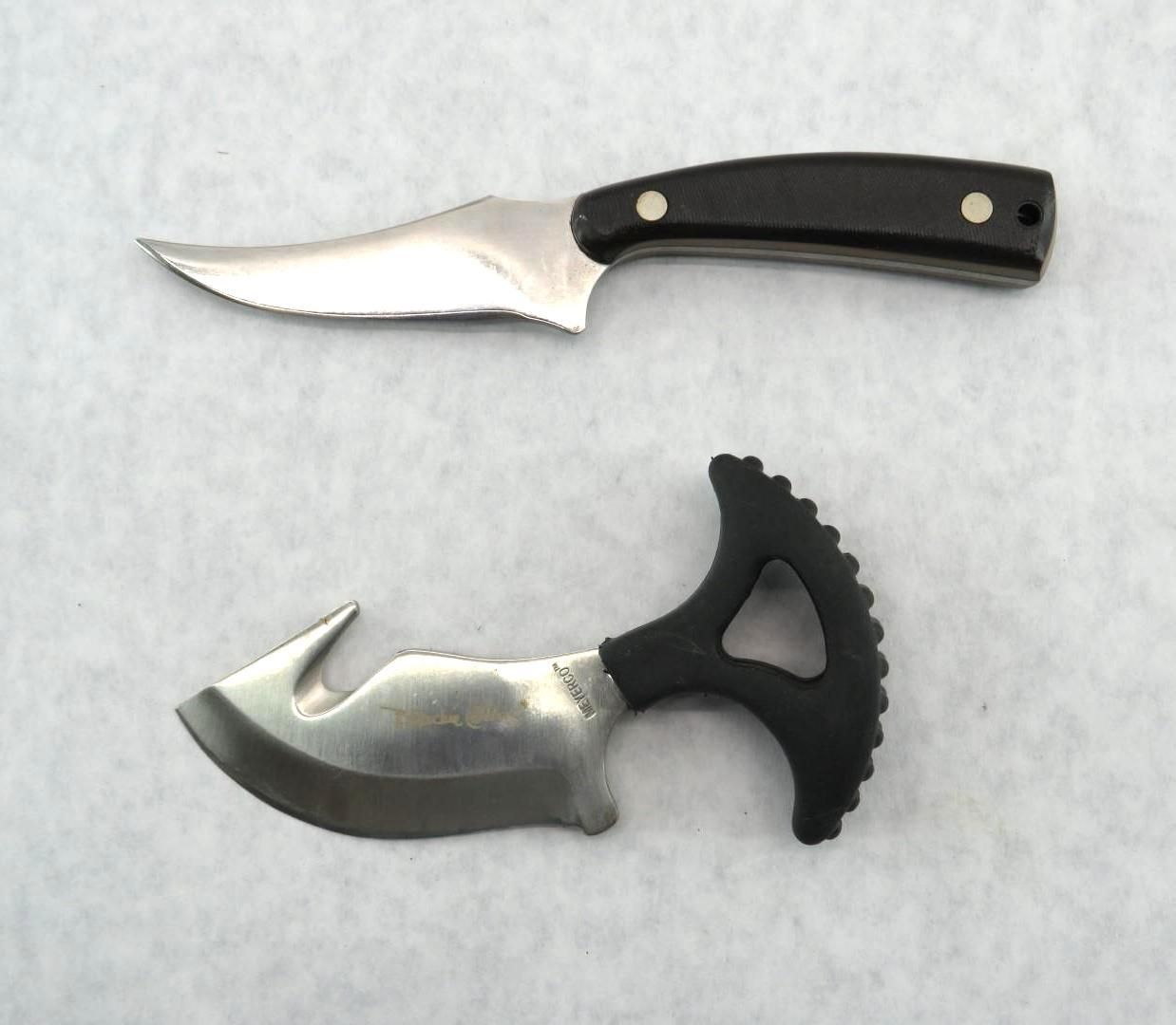 Two small knives on a light background: a straight black-handled knife and a curved hooked knife.