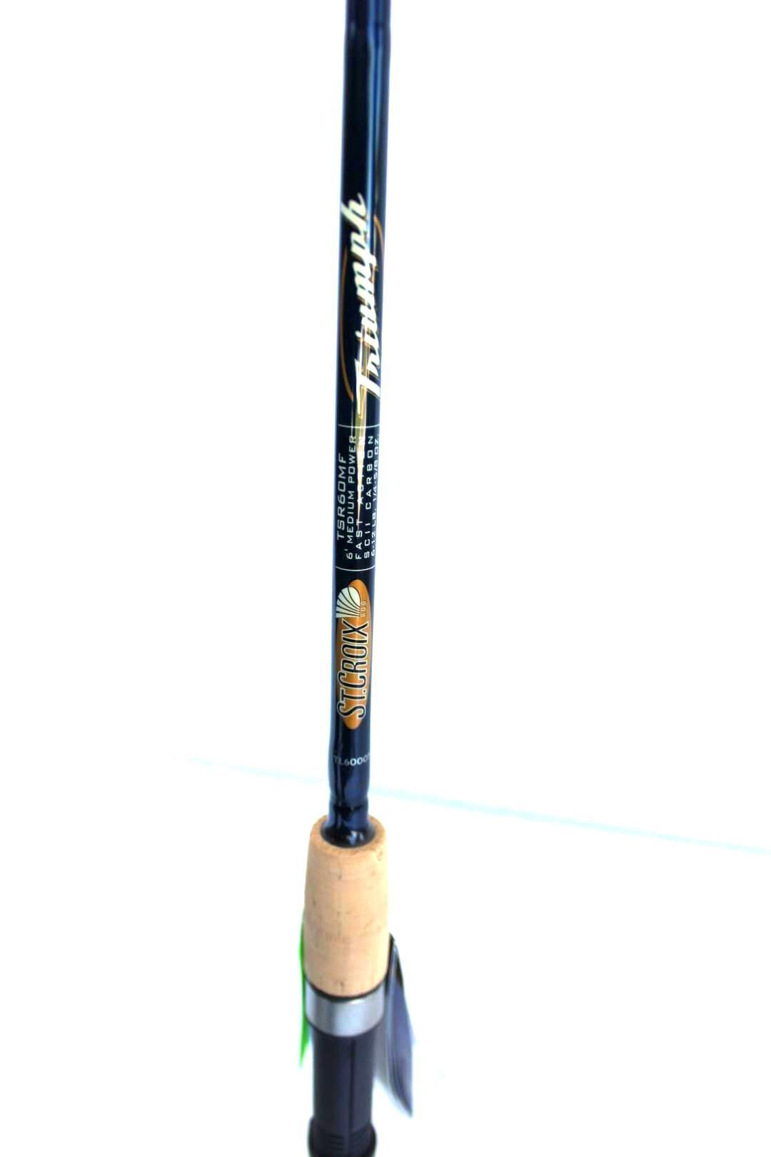 Close-up of a black fishing rod with cork handle and silver reel seat on a white background