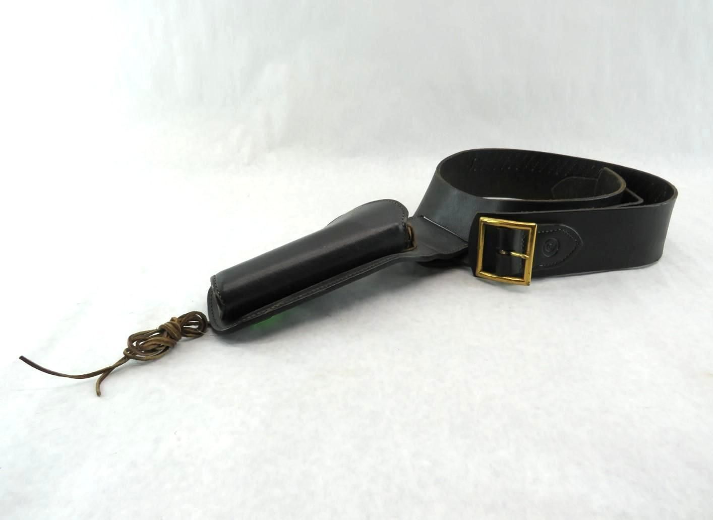 Black leather fishing gear with brass buckle and handle on a white background